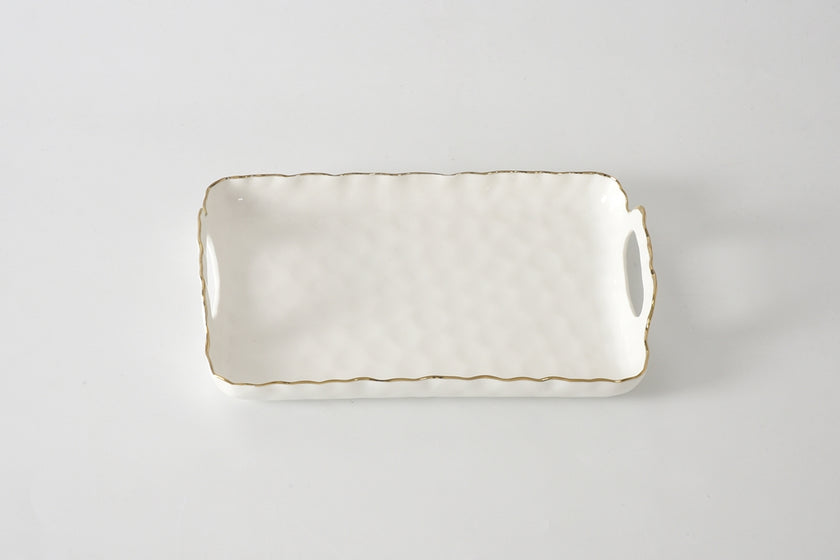 Rectangular ceramic tray with handles on a light gray background